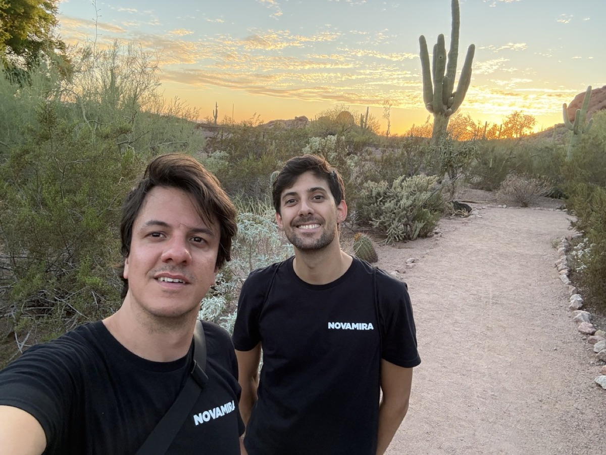Two members of the Novamira team hiking in the desert in Novamira t-shirts